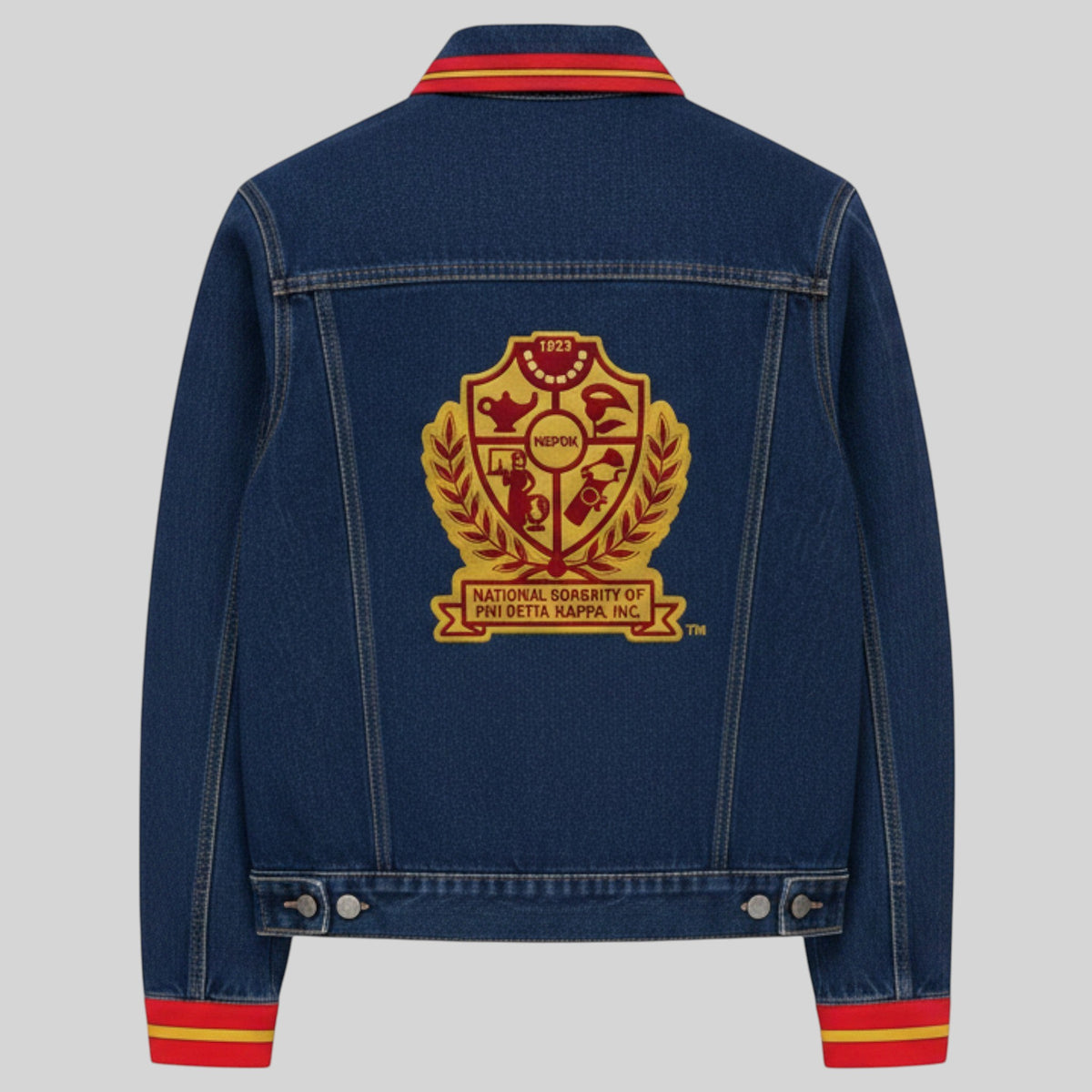 Pat Goffe Collections denim jacket featuring a large chenille-embroidered crest on the back and red and gold striped trim