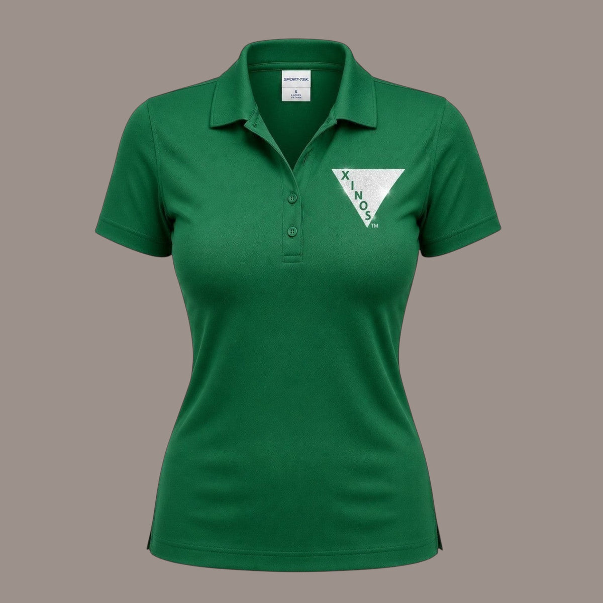 Pat Goffe Collections women's green short sleeve performance polo shirt with a white Xinos triangle logo on the chest.