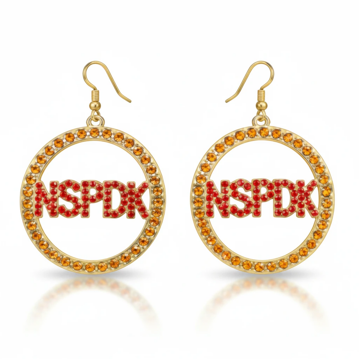 Pat Goffe Collections gold hoop earrings featuring red crystal NSPDK lettering and orange crystal accents.