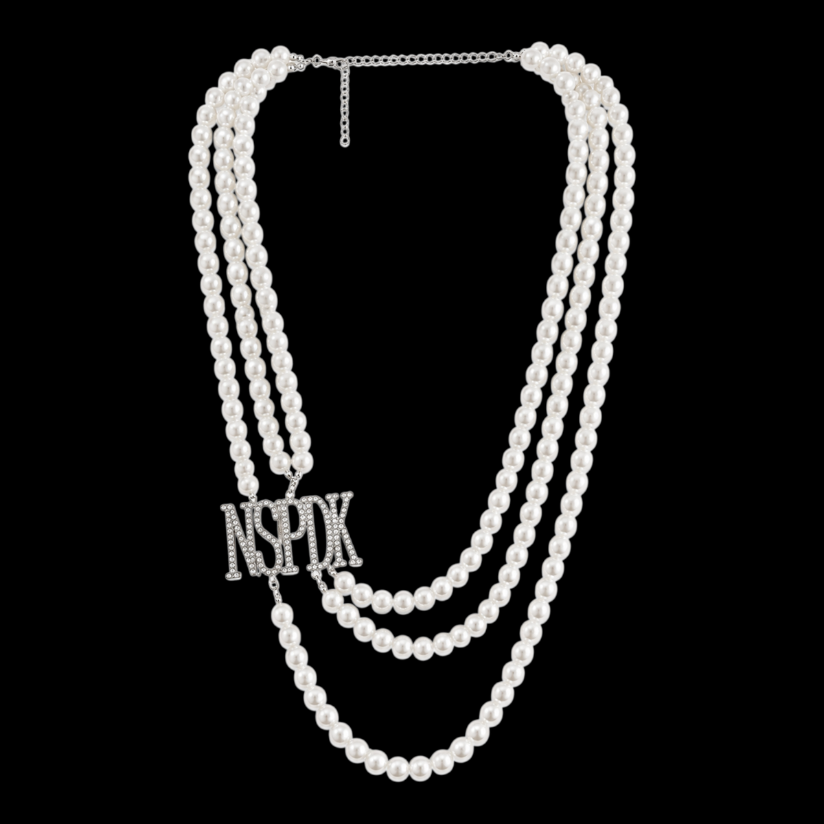 Pat Goffe Collections triple-strand white pearl necklace featuring a silver-tone rhinestone NSPDK logo pendant.