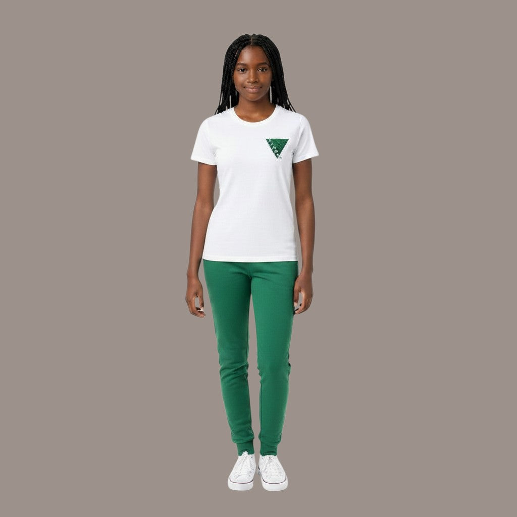 Pat Goffe Collections white crew neck t-shirt with a green triangular graphic, worn by a woman with green joggers.